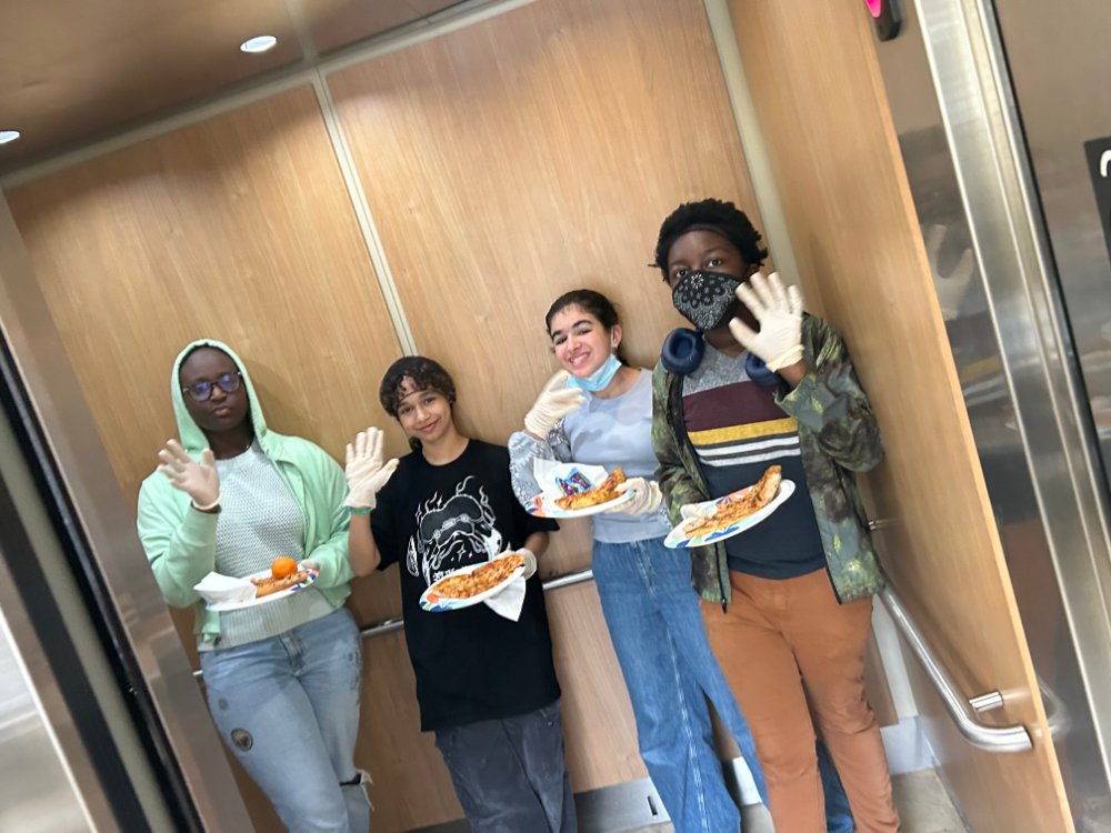 Four of the students delivering Domino's Pizza.