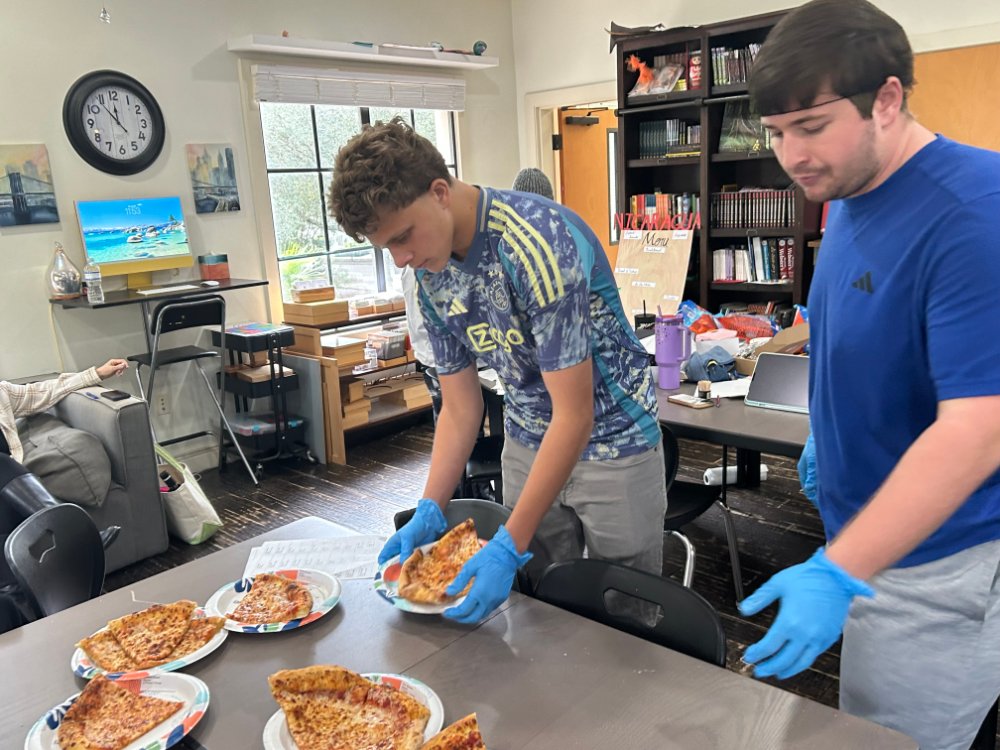 Two of the students prepping Domino's Pizza for delivery.